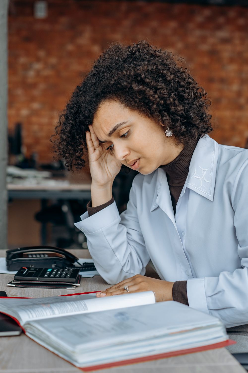 Stressed business owner covered in receipts